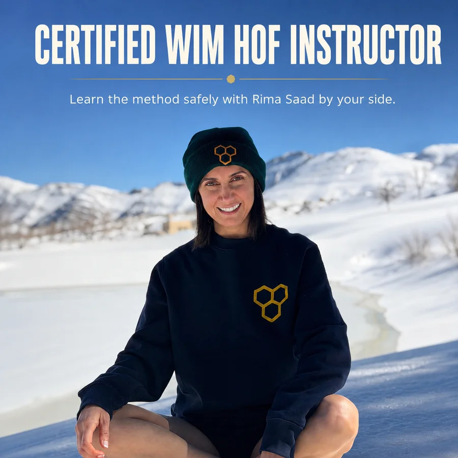 Rima Saad, Certified Wim Hof Method Instructor, sitting in a snowy mountain landscape