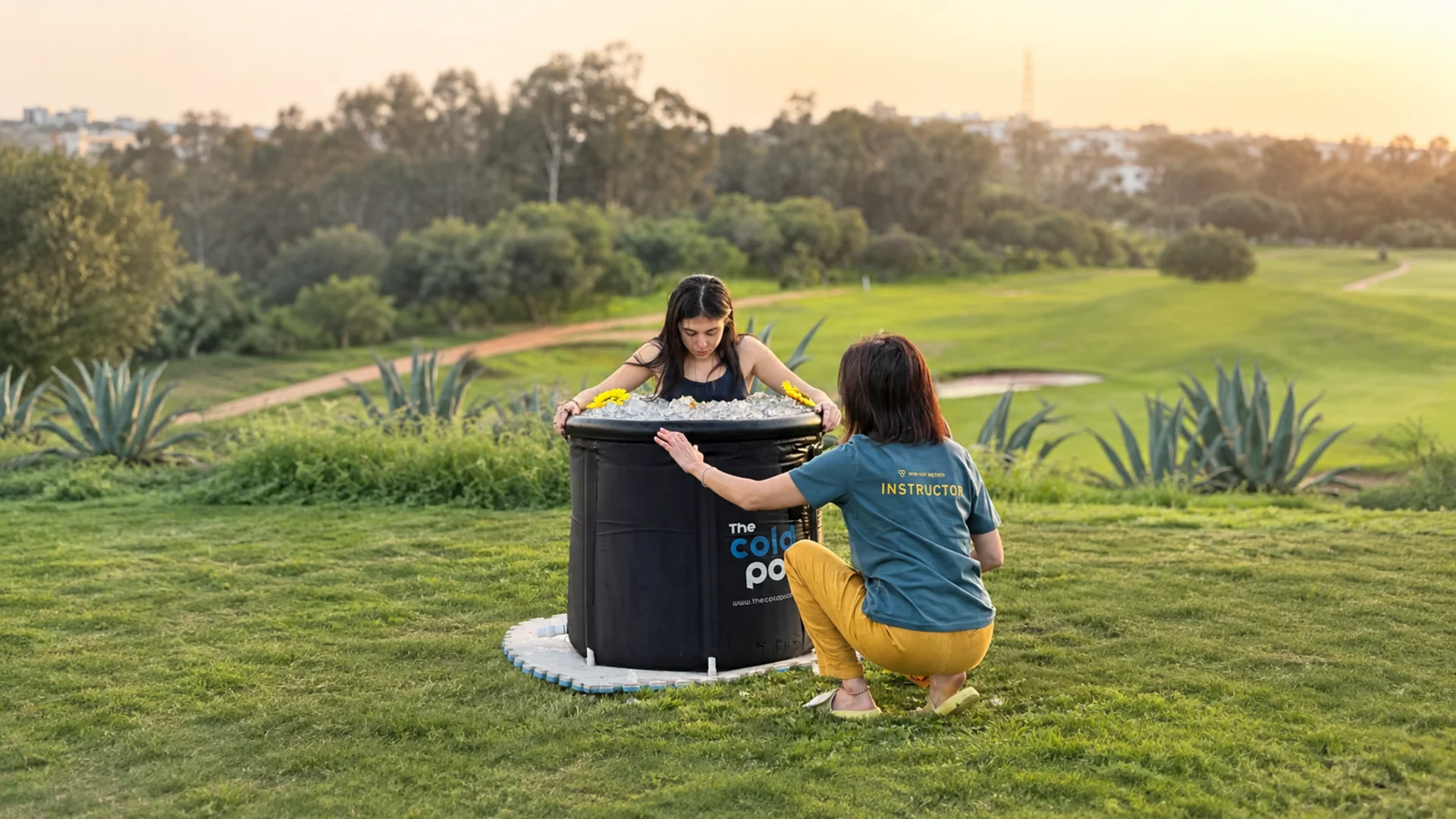 Rima Saad guiding a participant at an outdoor Wim Hof Method ice bath session
